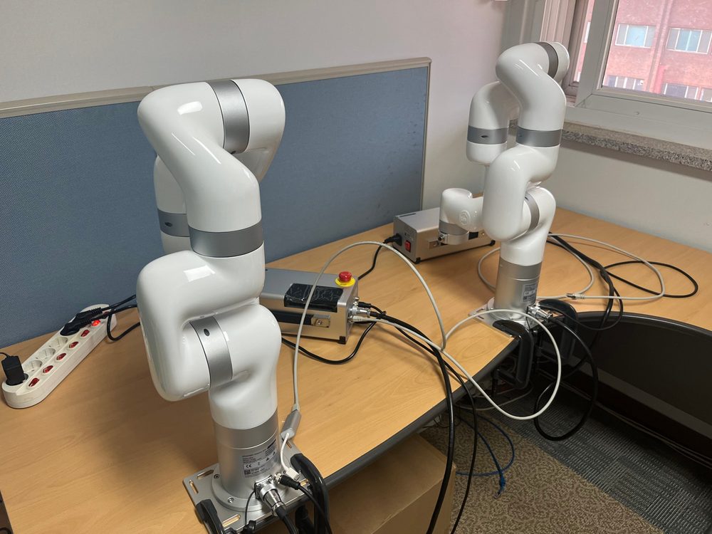In-house test setup with two white robot arms